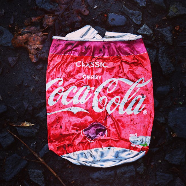 A large pile of black bin bags filled with rubbish, stacked against an exterior wall of a building with a tiled surface, some bags torn open revealing plastic bottles and paper debris inside. The wall has graffiti with the word 'XEND' spray-painted in red. The scene is outdoors, likely on a pavement or a driveway, with a cloudy sky visible in the background and a hint of an urban environment. The presence of the bags and litter suggests an issue with unmanaged waste or an alternative rubbish collection situation, illustrative of challenges faced by independent waste disposal services such as Waste Disposal Highbury when managing overflow or uncollected waste in residential areas.